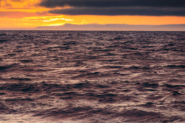 Fototapeta premium Sun setting on horizon over the Strait of Juan de Fuca, Port Angeles, Washington State, USA.
