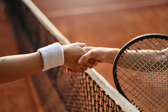 Fair play handshake after tennis match on clay court - Powered by Adobe