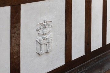 London, UK, 15 May 2025, The white relief sculpture made of plaster with a crest or emblem with an...