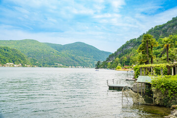 Obraz premium Spring view of Lake Lugano in the town of Caslano in the Swiss mountains