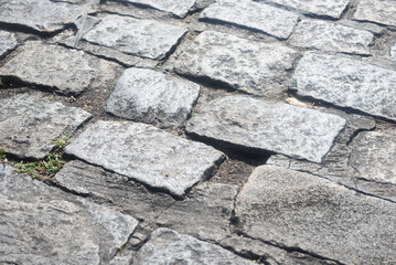 Texture of a street pavement with square and rectangular stones. Geometric pattern. Background. Abstract. Copy space.