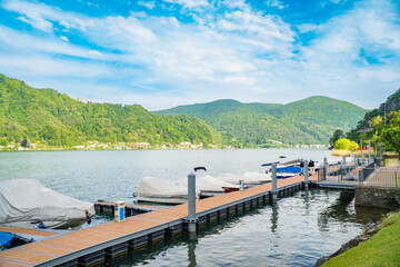 View of boats moored on Lake Lugano, village of Caslano. Switzerland