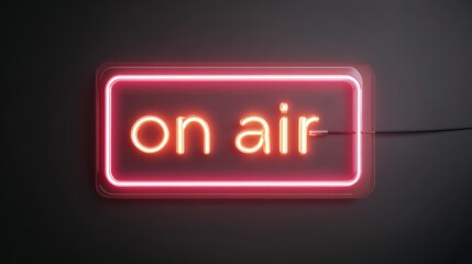 Neon "on air" sign glowing in dark studio setting