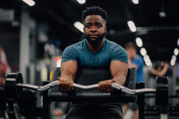Determined bodybuilder lifting weights, building muscles at gym