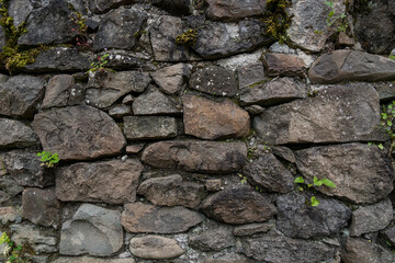 The stone wall of the old fortress of Gvara. The background is a stone wall