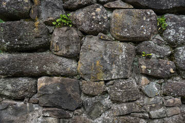 The stone wall of the old fortress of Gvara. The background is a stone wall
