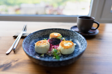 A plate of cheesecakes and a cup of morning herbal drink.