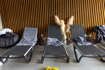 Sunbeds without people, with towels scattered around.