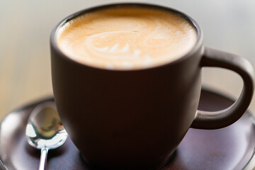 An extremely close-up of a cup of cappuccino.
