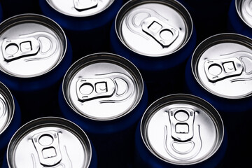 Aluminum soda cans top view. Cold drinks packed in silver. Repeating round shapes with tabs....