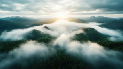 Obraz premium An aerial view of majestic mountains enveloped in mist during sunrise, showcasing the serenity and grandeur of nature in a breathtaking landscape photograph.