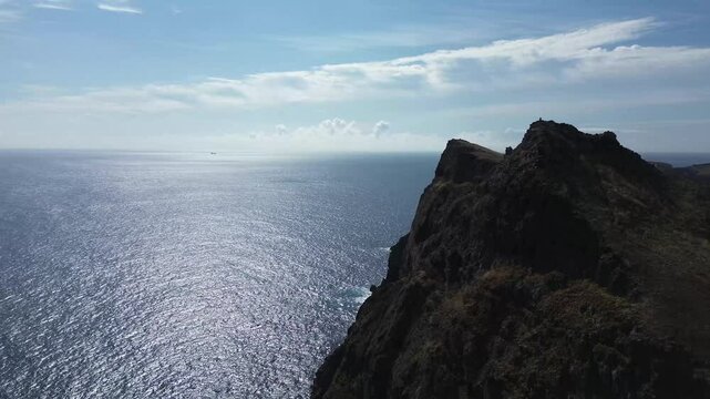Breathtaking aerial view of vibrant volcanic cliffs meeting the Atlantic Ocean at the edge of Madeira&rsquo;s wild peninsula &mdash; Praia do Sardinha and Vereda da Ponta de S&atilde;o Louren&ccedil;o captured in 4K cinematic 