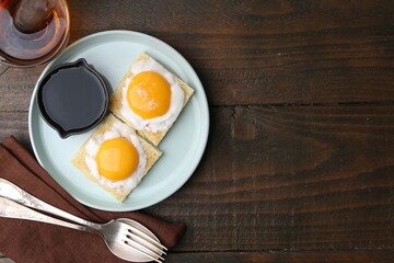 Traditional asian breakfast with tasty kaya toasts and half-boiled eggs served on wooden table, flat lay. Space for text