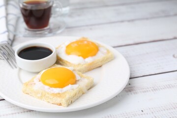 Traditional asian breakfast with tasty kaya toasts and half-boiled eggs served on white wooden table, closeup. Space for text