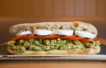 Chicken pesto sandwich with tomatoes and mozzarella cheese
