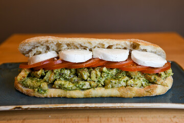 Chicken pesto sandwich with tomatoes and mozzarella cheese