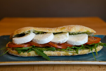 Ciabatta sandwich with mozzarella, tomatoes and arugula