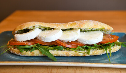 Ciabatta sandwich with mozzarella, tomatoes and arugula