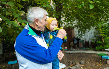 A man is holding a baby in his arms