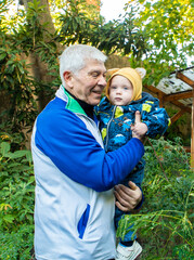 A man is holding a baby in his arms