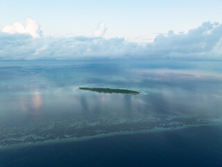 Evening light illuminates an island within Wakatobi National Park, off the coast of Sulawesi. This area is a popular destination for divers and snorkelers due to its high marine biodiversity.
