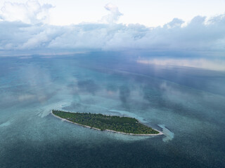 Evening light illuminates an island within Wakatobi National Park, off the coast of Sulawesi. This area is a popular destination for divers and snorkelers due to its high marine biodiversity.