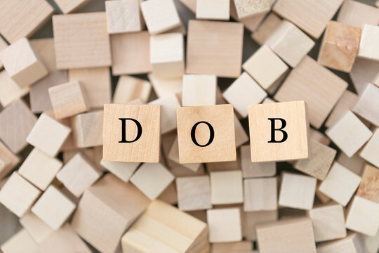 DBO (Date of birth) concept. Abstract geometric wooden dice. DBO icon.