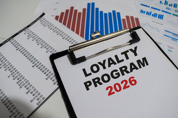 Concept of Loyalty Program 2026 write on paperwork isolated on Wooden Table.