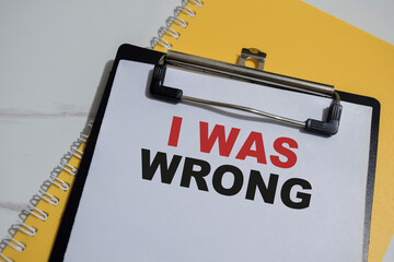 Concept of I was wrong write on paperwork isolated on Wooden Table.