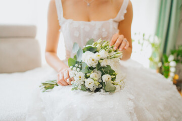bride holding bouquet of flowers in her lap