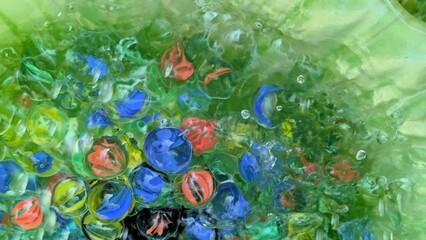 Clear marbles in water - abstract colorful background with glass marbles  