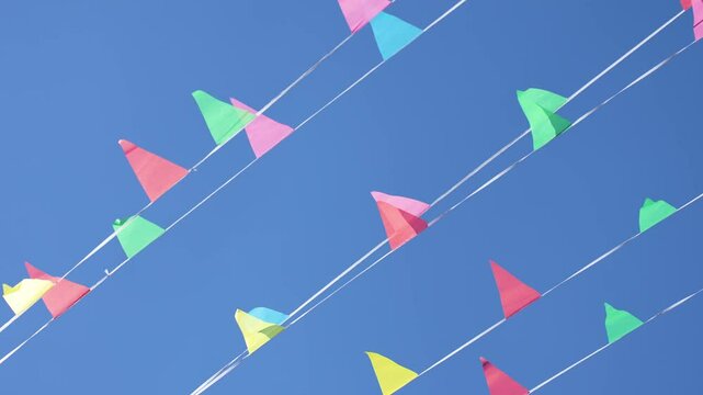 multicolored flags on a blue sky background