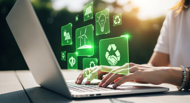 Person typing on laptop with green energy icons floating above the keyboard in an outdoor setting