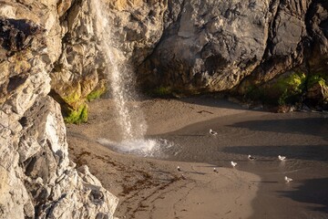 McWay Falls tumbles onto the beach at Julia Pfeiffer Burns State Park. The waterfall flows...