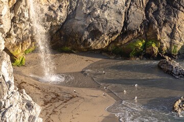 McWay Falls tumbles onto the beach at Julia Pfeiffer Burns State Park. The waterfall flows...
