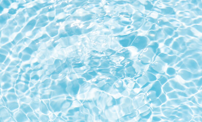 Blue water with ripples on the surface. Defocus blurred transparent blue colored clear calm water surface texture with splashes and bubbles. Water waves with shining pattern texture background.