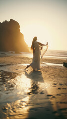 A girl in a sari dances against the backdrop of the ocean at sunset. Meditation.  Yoga. Soft focus
