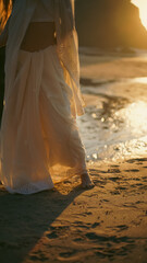A girl in a sari dances against the backdrop of the ocean at sunset. Meditation.  Yoga. Soft focus