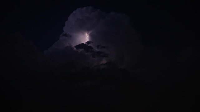 Colorful Lightning Bolt emerging from top of Storm Cloud in Super Slow Motion. Closeup.
