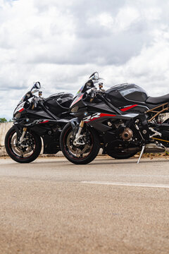 Side profile of two black BMW S1000RR superbikes