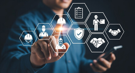 Man interacting with safety and business icons on a digital interface with a dark background