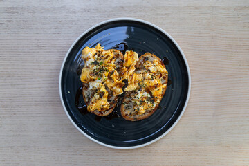 A plate of scrambled eggs on sourdough.