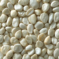 A full frame close up photograph of smooth cream colored rounded pebbles background image