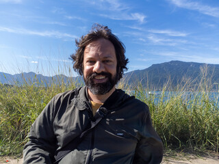 Very happy millennial man playing with his drone on a mountain at 40 years old