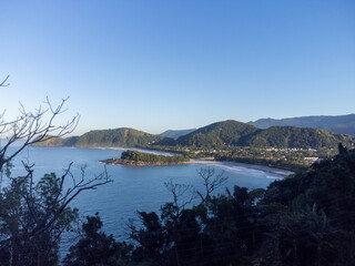 Small island between two beaches with green waters Camburi
