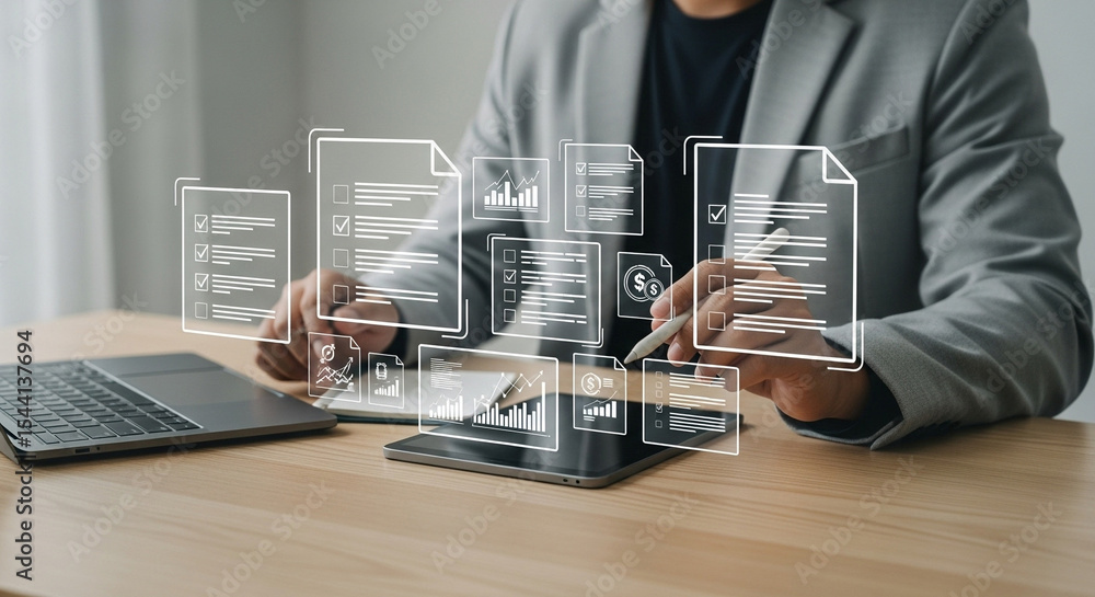 Poster man in suit interacting with digital documents on tablet and laptop on wooden desk surface