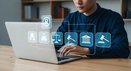 Man using laptop with legal icons overlayed for copyright trademark and intellectual property law