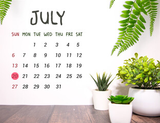 Wooden calendar July 20 on a white background close up