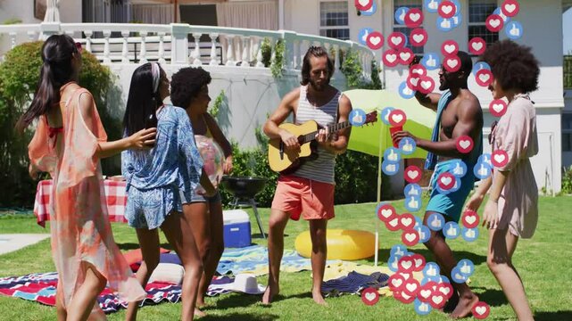 Guitarist playing guitar on lawn, friends tossing beach ball toasting earning live stream reactions