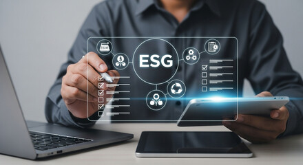 Man using digital interface with esg icons on laptop and tablet for environmental social governance